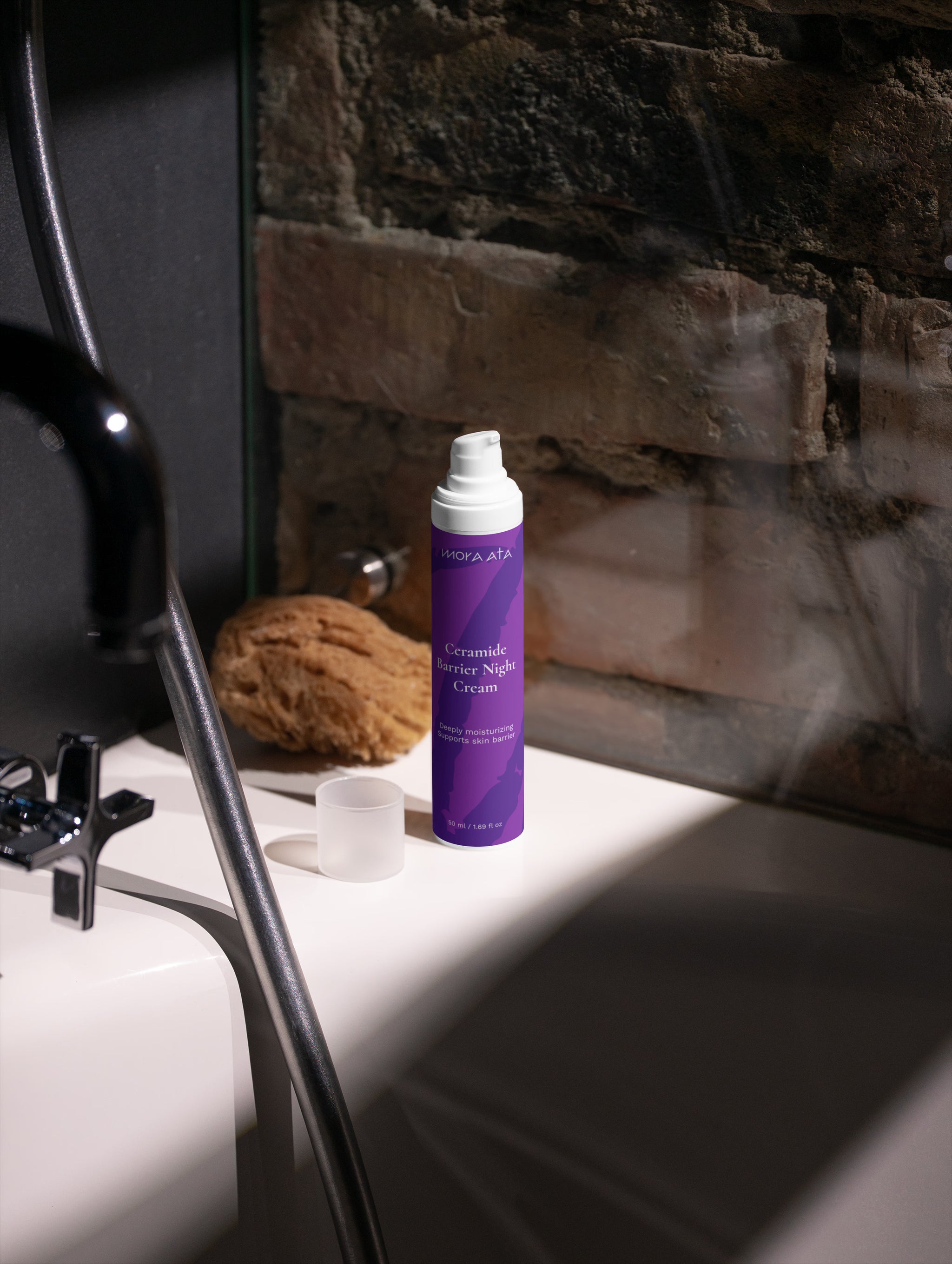 Mora Ata Ceramide Barrier Night Cream  on a bathroom counter with a stone wall background