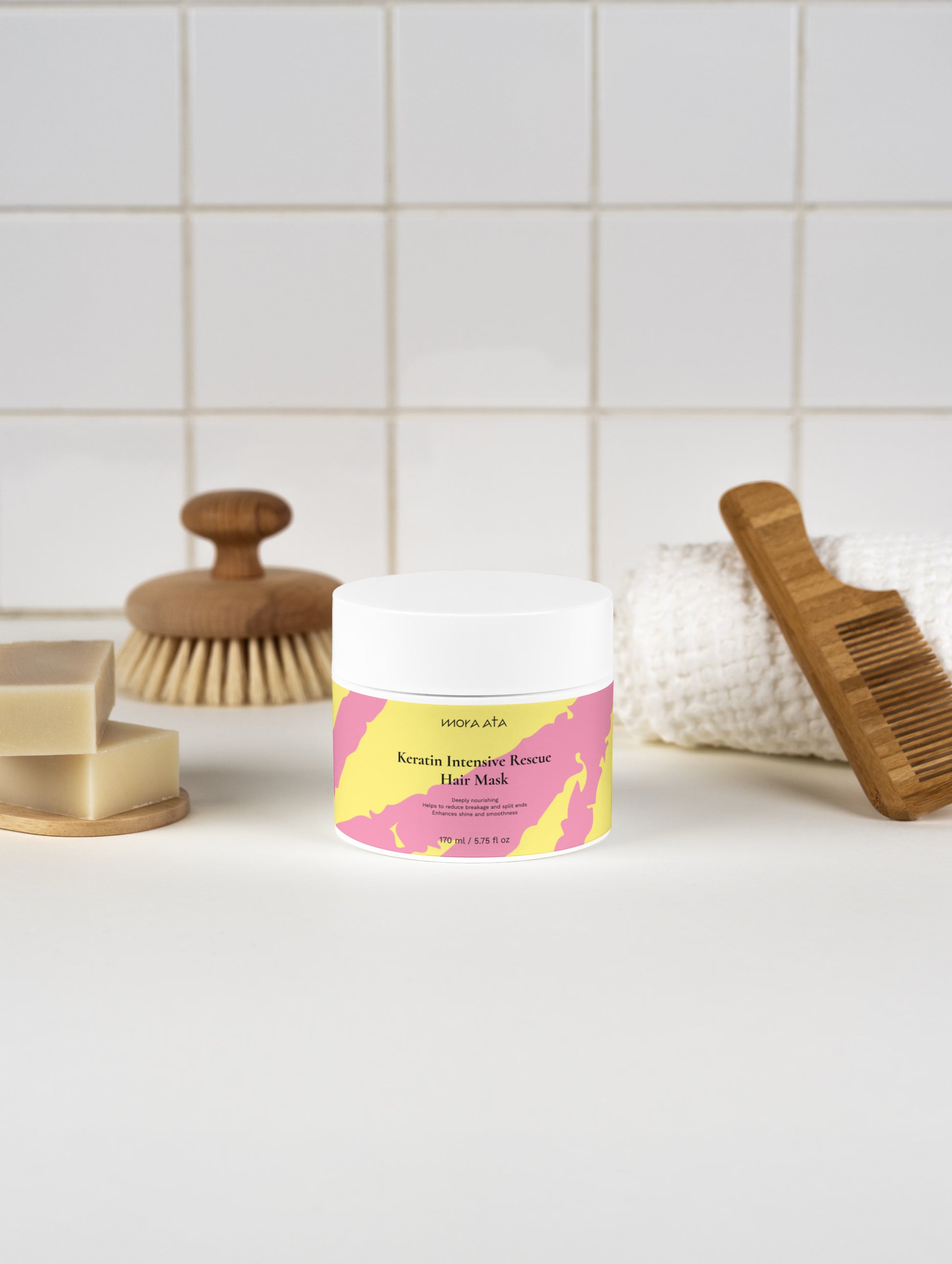 Keratin Intensive Rescue Hair Mask on a bathroom counter with a brush and soap in the background.