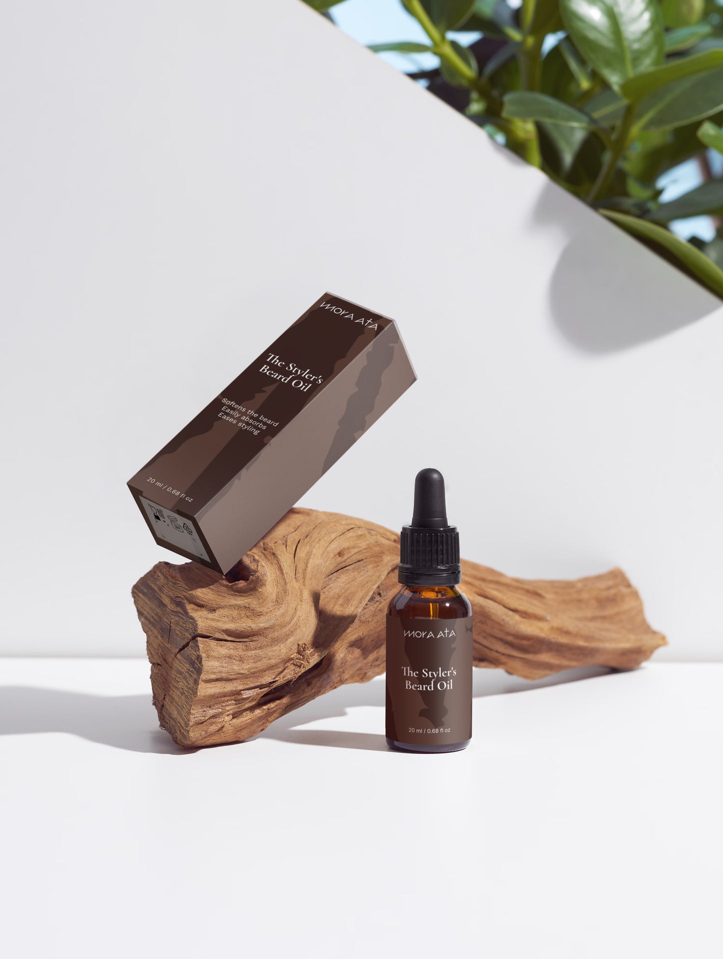 Mora Ata The Styler's Beard Oil bottle  with packaging on a natural wood and stone background